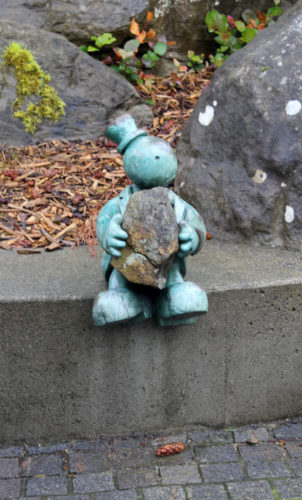 sculpture with rock and man